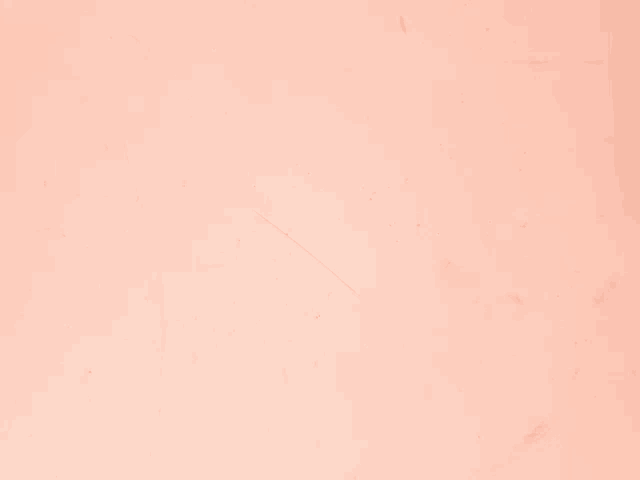 a close up of a peach colored surface with a few spots on it