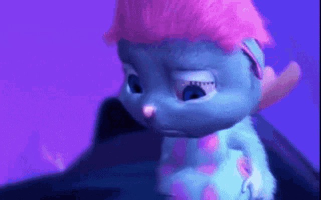 a blue cartoon character with pink hair is looking down .