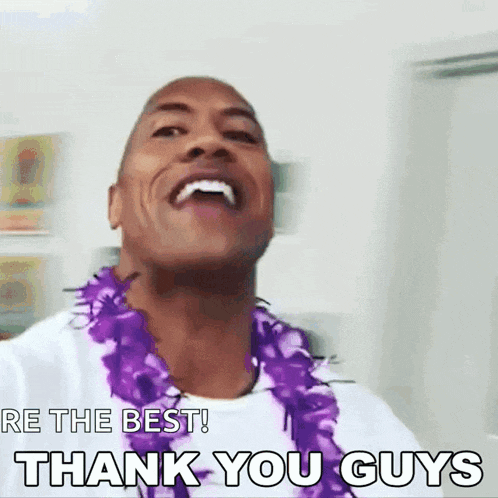 a man wearing a purple lei is smiling and saying thank you guys