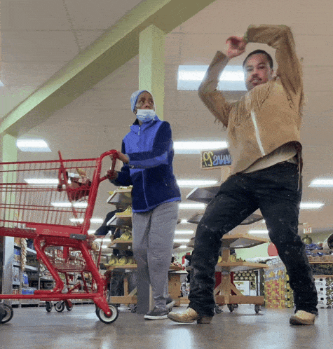 a man and woman are dancing in a grocery store with a sign that says 2 way