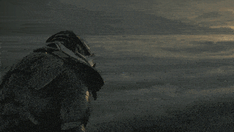 a statue of a monster stands in the clouds
