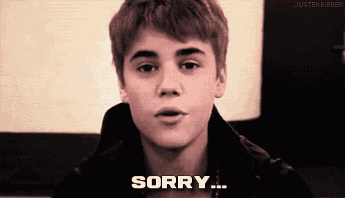 justin bieber is making a face and saying " sorry "