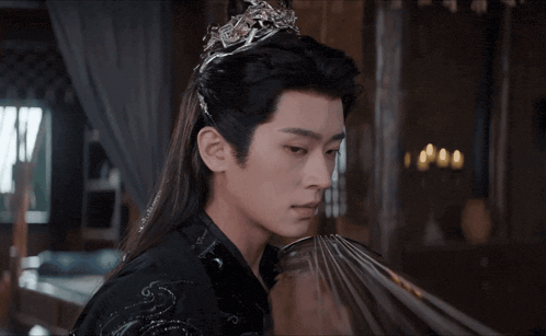 a man with long hair and a crown on his head