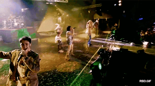 a group of people dancing on a stage with a watermark that says rbd.gif on the bottom
