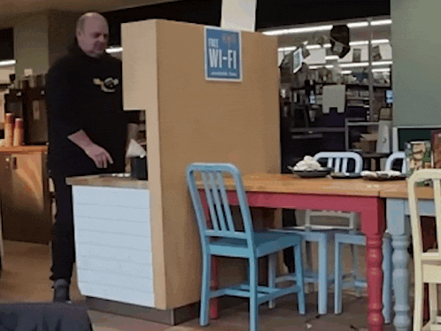 a man standing in front of a free wi-fi kiosk
