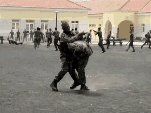 a group of soldiers are fighting in a field