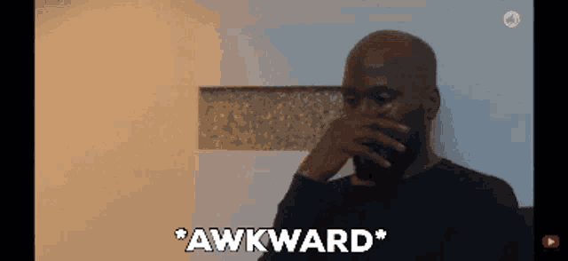 a man is covering his mouth with his hand and the word awkward is written below him