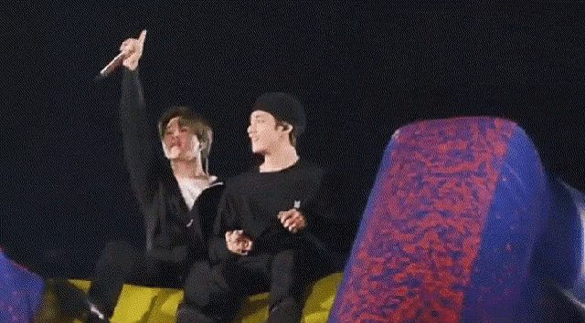 two men are sitting on a couch with their arms in the air and the words army written on the bottom