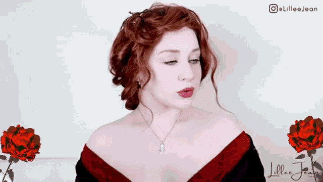 a woman with red hair is wearing a necklace and a red dress