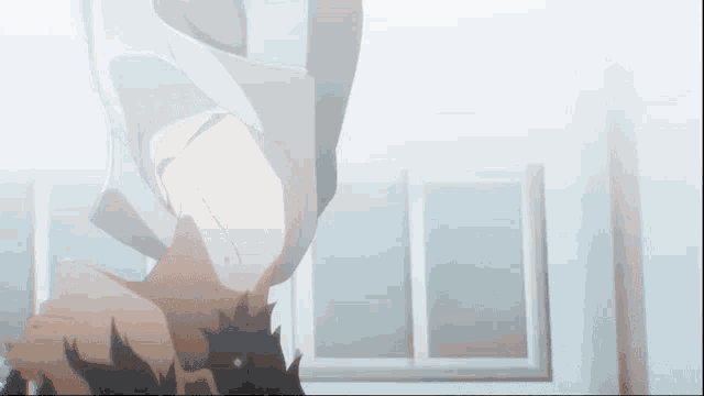 a man is upside down in a room with a window .
