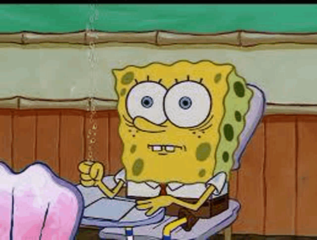 spongebob is sitting at a desk in a classroom with a straw in his mouth .