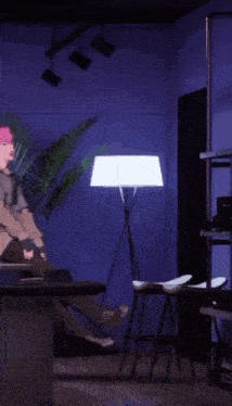 a man with pink hair is standing in a room with a purple wall