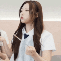 a girl in a white shirt and tie is holding a stick