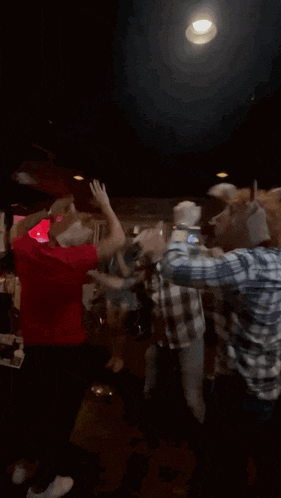 a man in a red shirt that says ' i love you ' on it is dancing in a dark room