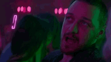 a man is looking up at a neon sign that says `` i lied '' .