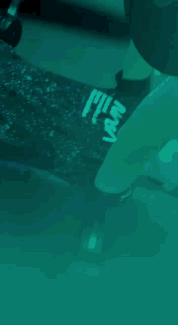 a person lifting a dumbbell in a gym with a shirt that says fly on it