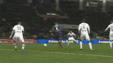 a soccer game is being played on a field with a sign that says audi q2