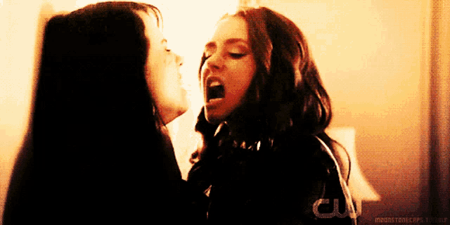 two women are screaming at each other with a cw logo behind them