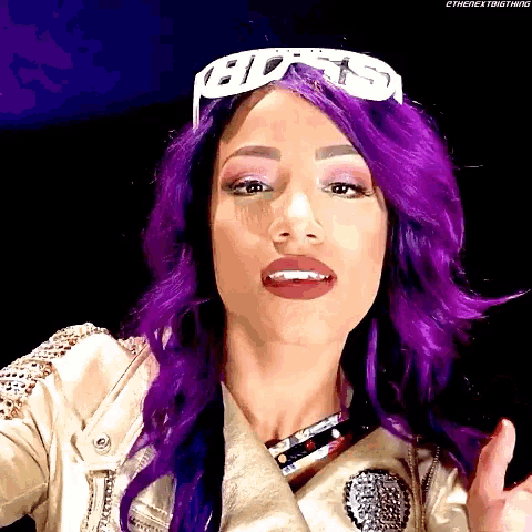 a woman with purple hair is wearing a crown and sunglasses