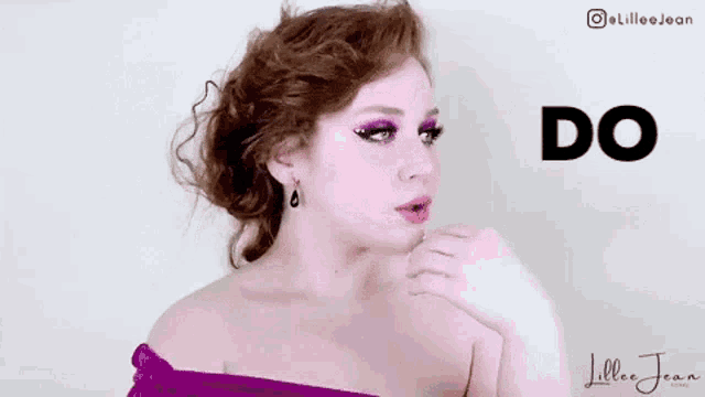a woman with red hair is wearing a purple dress and earrings and is making a face .