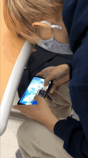 a person playing a game on a cell phone