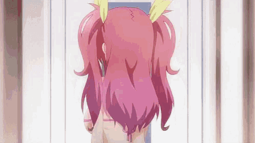 a girl with pink hair is standing in front of a white wall .