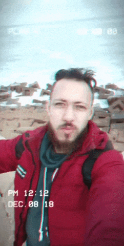 a man in a red jacket takes a selfie with the date dec 08 18 on the bottom