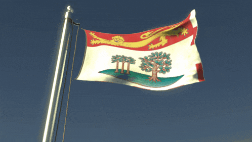 a flag with trees and a lion on it is waving in the wind