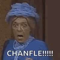 a woman wearing a blue hat is covering her mouth with her hands and says chanfle !!! .