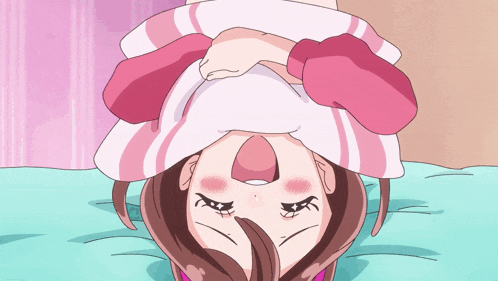 a girl is laying upside down on a bed with her eyes closed