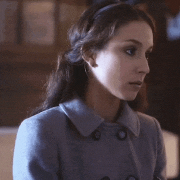 a woman wearing a blue coat and a headband