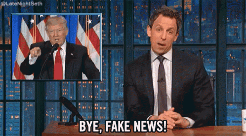 a man in a suit says bye fake news in front of a picture of donald trump