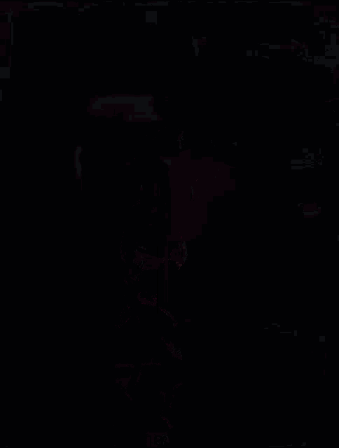 a girl with green hair is kneeling down in a dark room