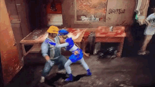 a man and a woman are fighting in a room with a sign that says 062197528 on it