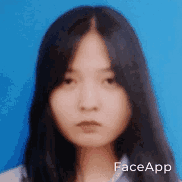 a close up of a woman 's face with faceapp written on the bottom right