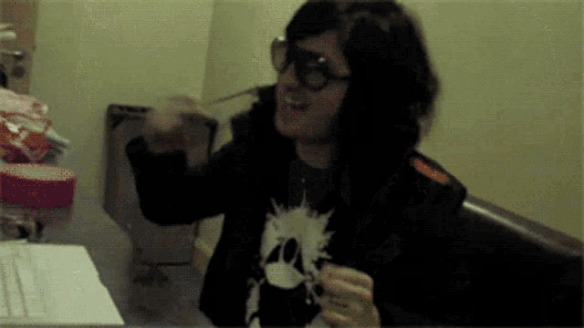 a person wearing a black shirt with a skull on it