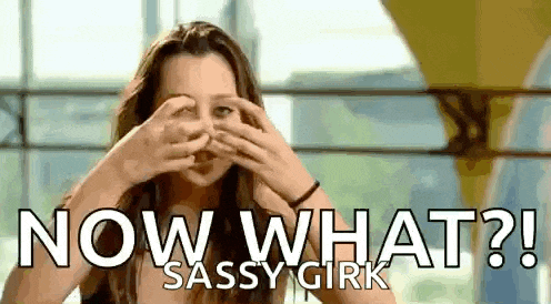 a woman is covering her eyes with her hands and the words `` now what ? '' are behind her .