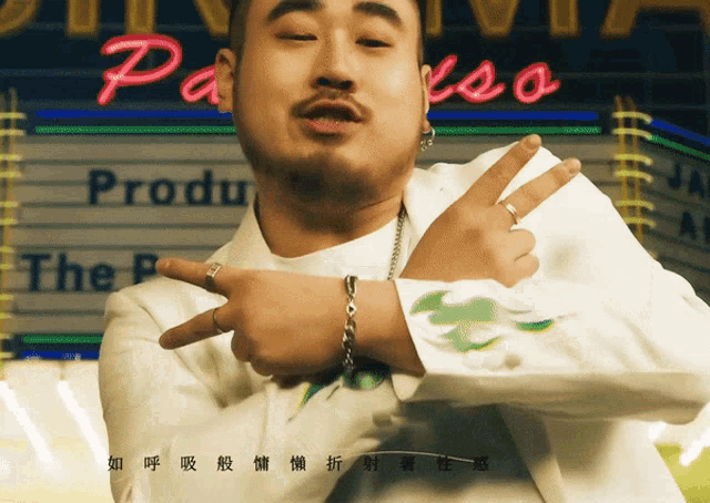a man in a white suit is standing in front of a sign that says " the producer "