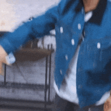 a man wearing a blue denim jacket and a white shirt