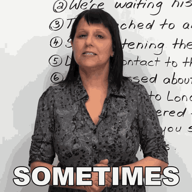 a woman stands in front of a white board with the words sometimes on it