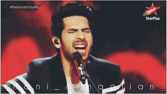 a man singing into a microphone with the words #thevoiceonstarplus above him