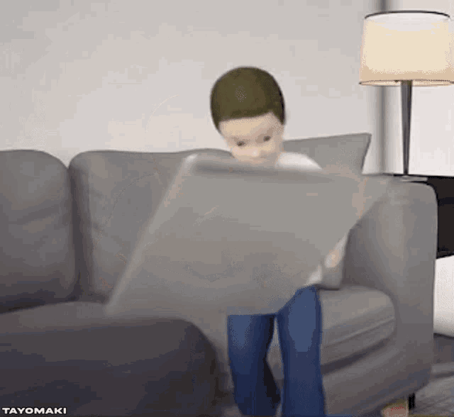 a boy is sitting on a couch looking at a tablet .