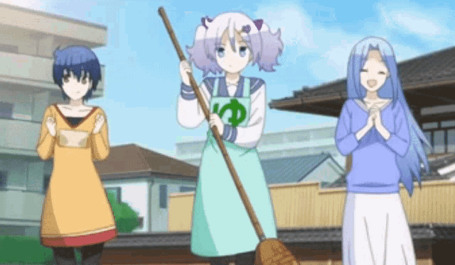 a girl in a green apron is holding a broom in front of two other girls