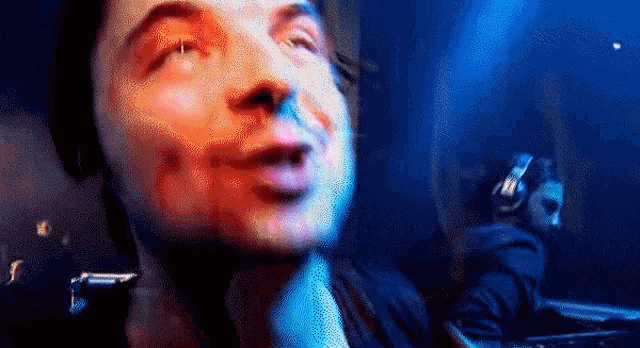 a close up of a man 's face with a blurred background