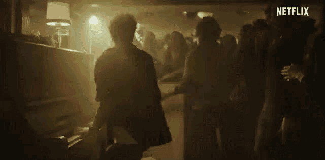 a man playing a piano in front of a crowd with netflix written on the bottom