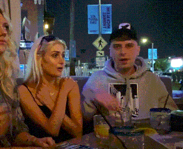 a group of people are sitting at a table in front of a sign that says ' la county theatre '