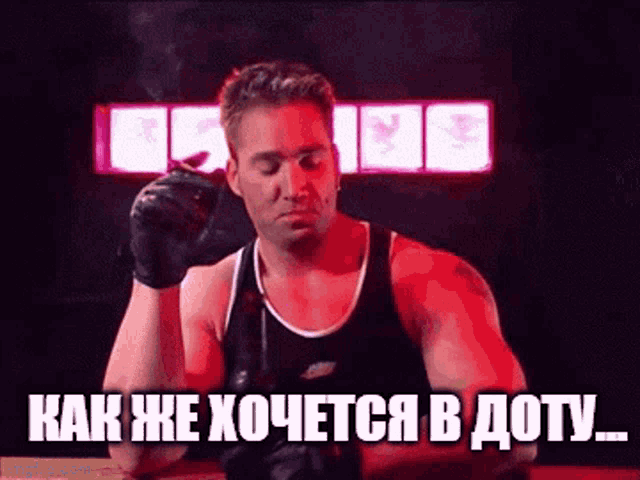 a man in boxing gloves is smoking a cigarette in a boxing ring ..