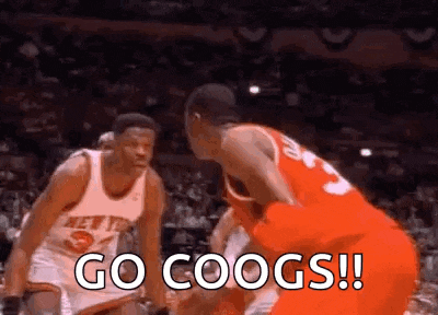 two basketball players are playing a game of basketball and one of them is shouting `` go coogs '' .