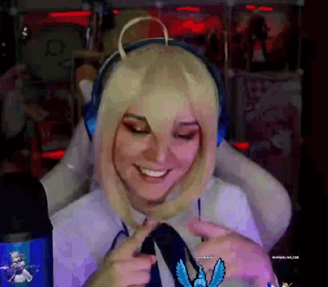 a woman wearing headphones and a wig is smiling in front of a microphone