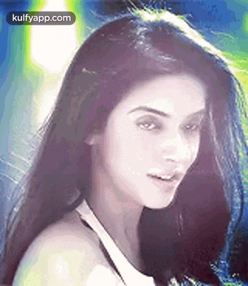 a close up of a woman 's face with long dark hair .